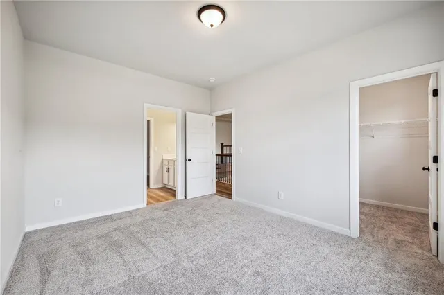 a view of a lake with a yard and large trees