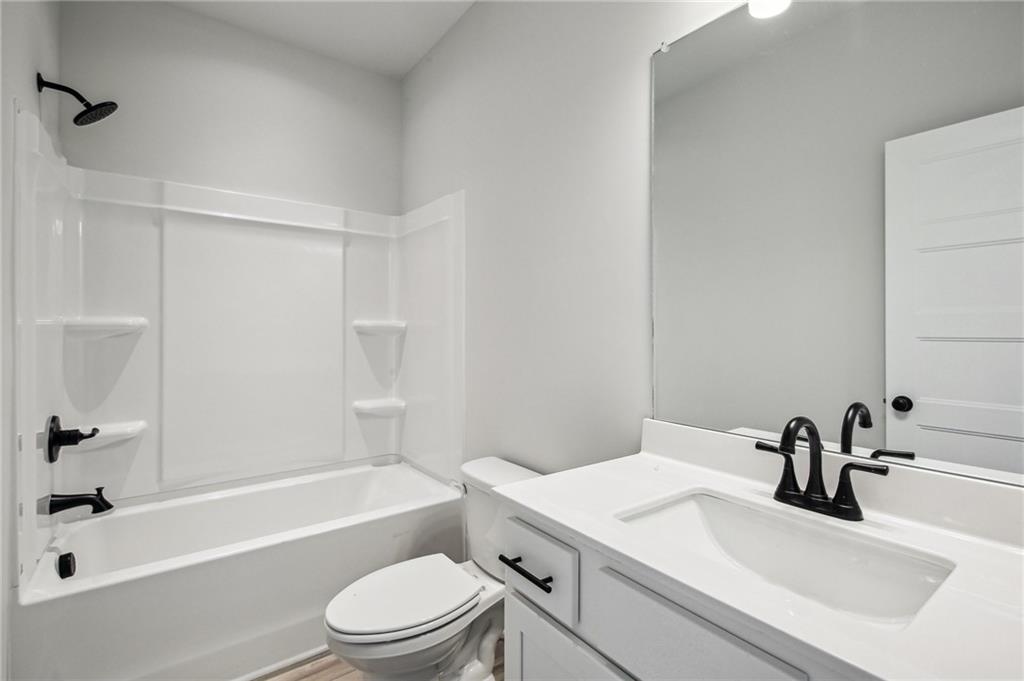 369 Scarlet Rose Way Hoschton, GA 30548 - Photo 37 of 150 a bathroom with a sink a toilet and a bathtub