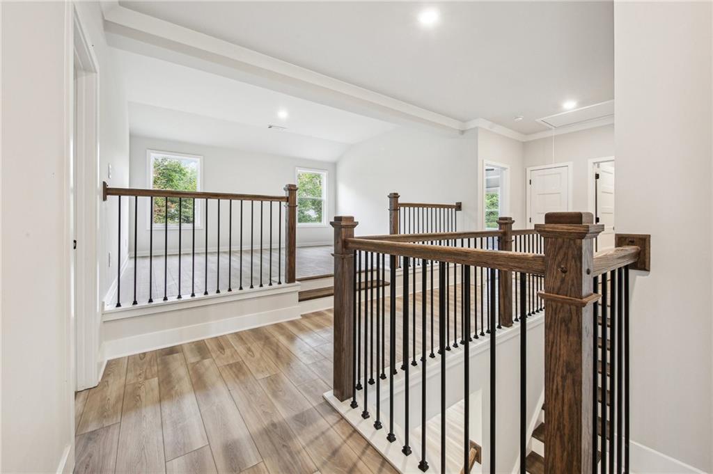 369 Scarlet Rose Way Hoschton, GA 30548 - Photo 45 of 150 a view of a hallway with wooden floor and windows