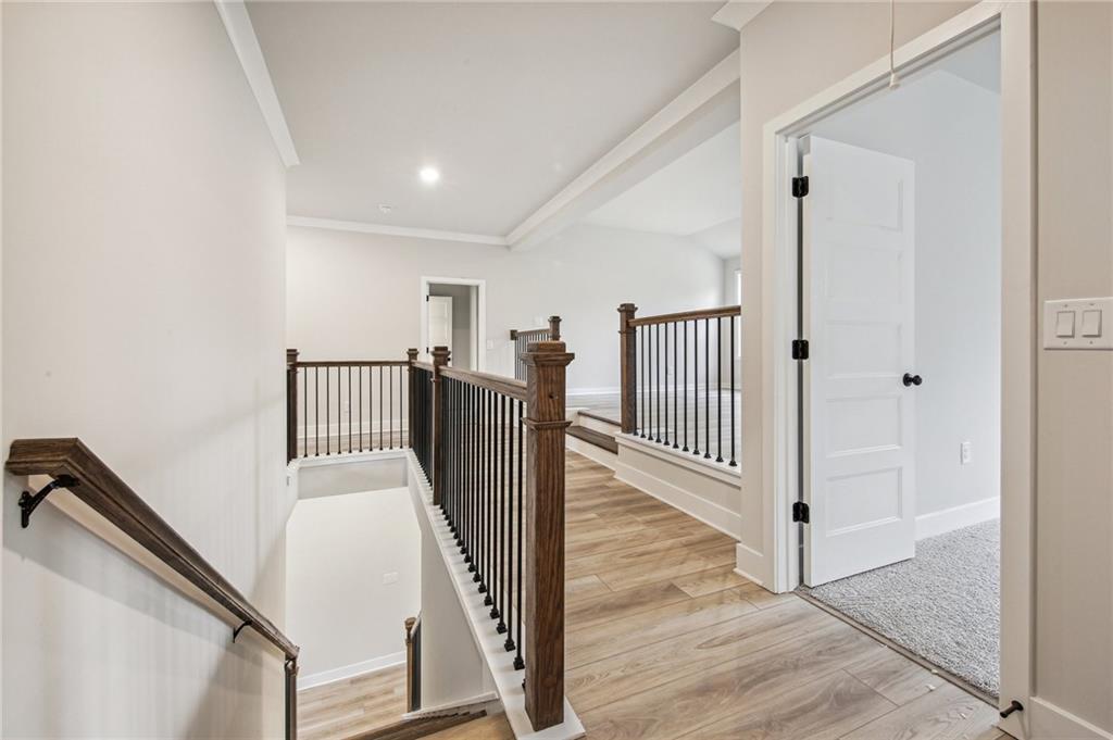 369 Scarlet Rose Way Hoschton, GA 30548 - Photo 46 of 150 a view of a hallway with staircase