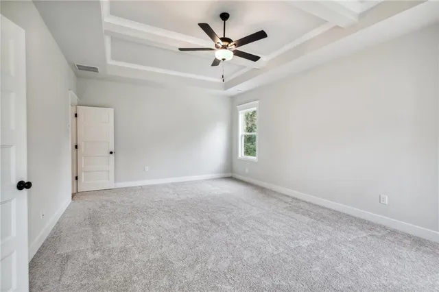 a front view of a house with a garden and plants