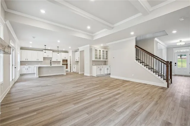 a kitchen with stainless steel appliances kitchen island granite countertop a sink a stove and a refrigerator