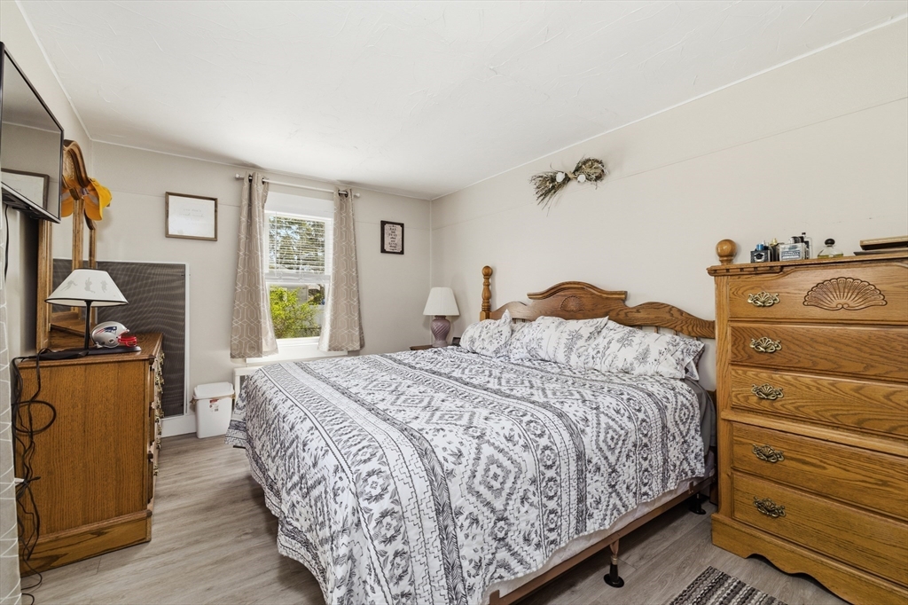 6 Birch Street Wareham, MA 02571 - Photo 12 of 25 a bedroom with a bed and wooden floor