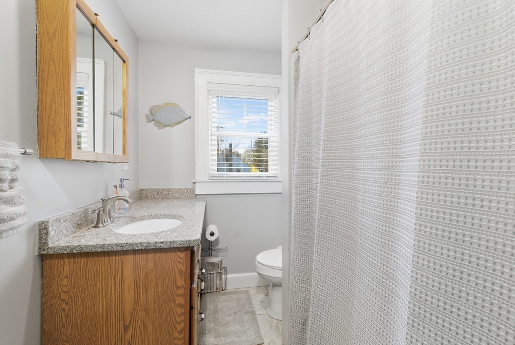 6 Birch Street Wareham, MA 02571 - Photo 13 of 25 a bathroom with a granite countertop sink toilet and mirror