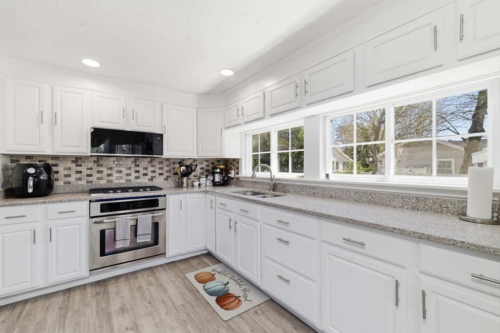 6 Birch Street Wareham, MA 02571 - Photo 5 of 25 a kitchen with sink cabinets and stainless steel appliances