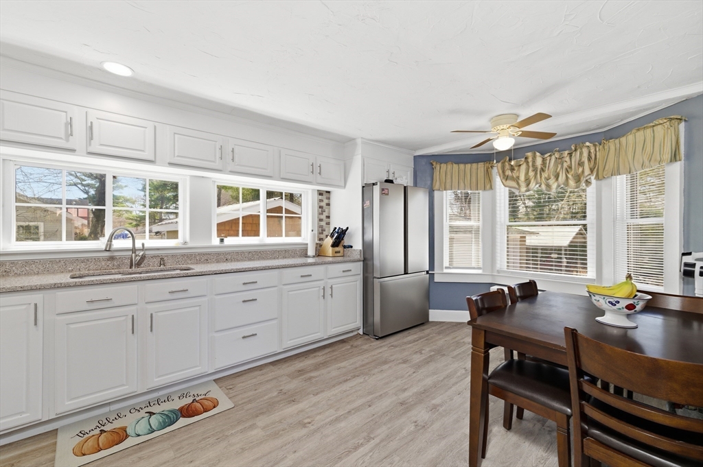 6 Birch Street Wareham, MA 02571 - Photo 6 of 25 a view of a kitchen with granite countertop a dining table chairs sink and wooden floor