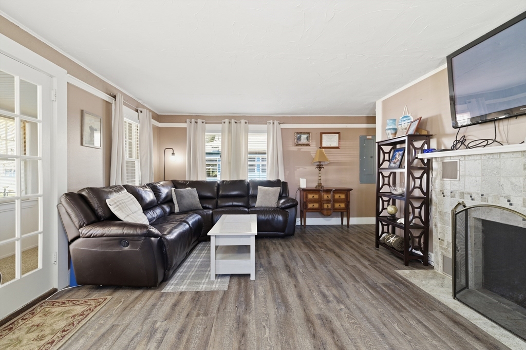 6 Birch Street Wareham, MA 02571 - Photo 8 of 25 a living room with furniture a fireplace and a flat screen tv