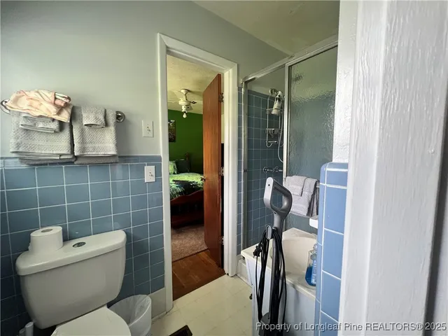 a bathroom with a toilet and a shower