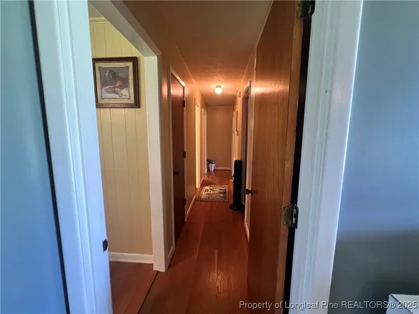 a view of a hallway with wooden floor