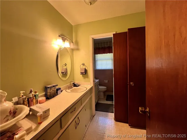 a bathroom with a double vanity sink and mirror