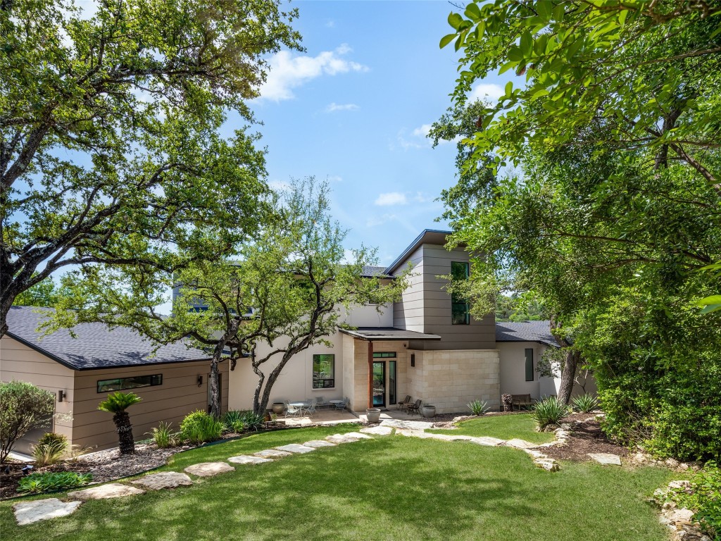 front view of a house with a tree in the yard