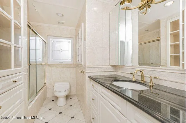 a bathroom with a granite countertop sink toilet a mirror and shower
