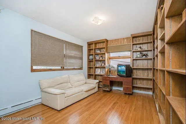 a living room with furniture a rug and a book shelf