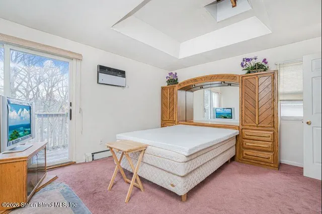 a spacious bedroom with a bed and a window