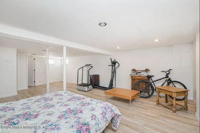 a bedroom with a bed and a mirror