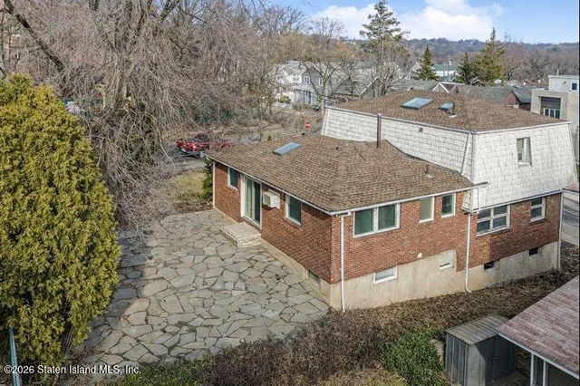 an aerial view of a house with a yard
