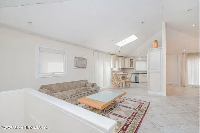 a living room with kitchen island furniture and a rug