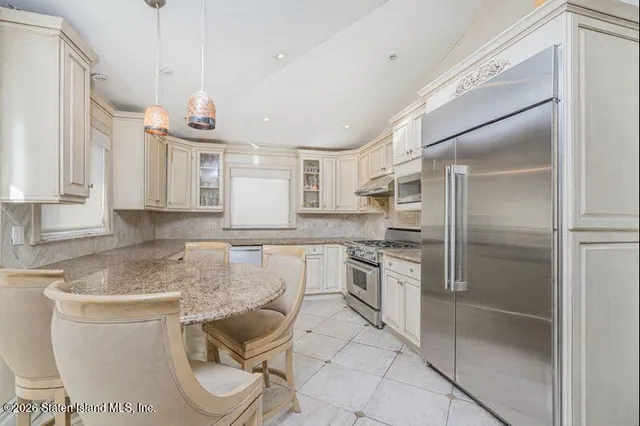 a kitchen with a sink cabinets and stainless steel appliances