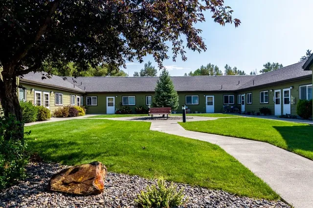 a front view of a house with a yard table and dinning table