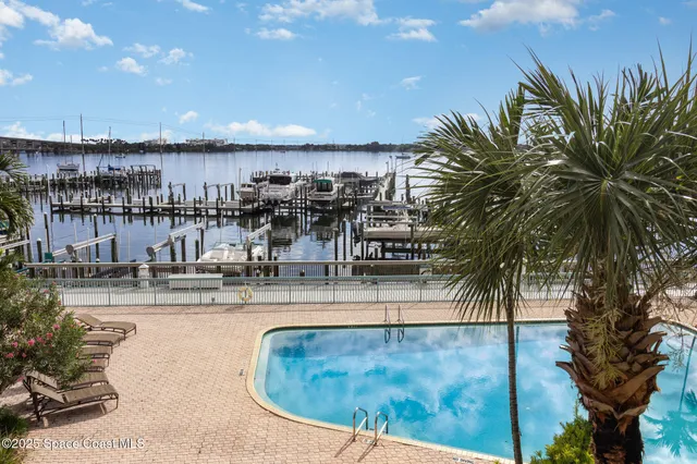 a view of roof deck with dining table and chairs