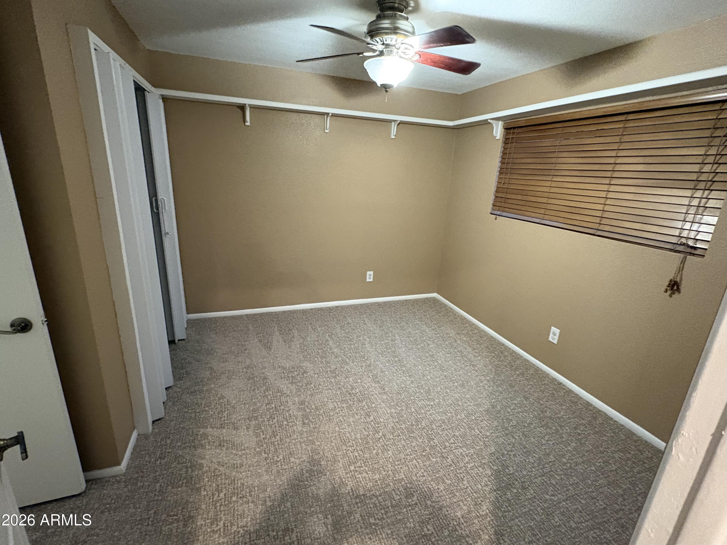 5525 East Thomas Road, Unit A2 Phoenix, AZ 85018 - Photo 5 of 11 a view of a room with wooden floor and fan