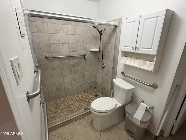 a white toilet sitting next to a bathroom sink