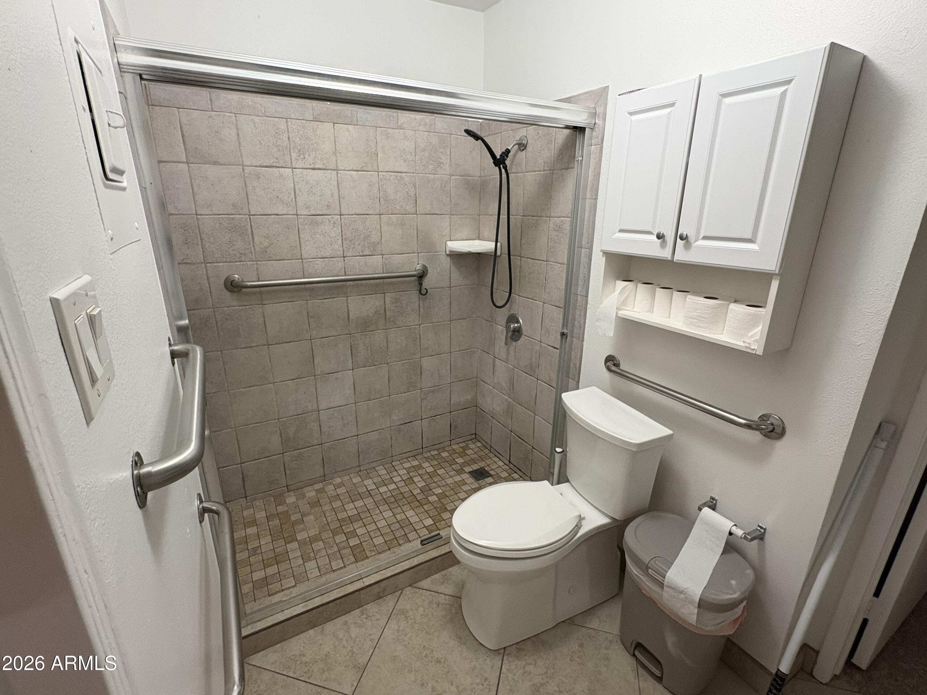 5525 East Thomas Road, Unit A2 Phoenix, AZ 85018 - Photo 7 of 11 a white toilet sitting next to a bathroom sink
