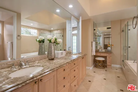 a bathroom with a granite countertop sink mirror and double
