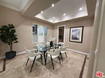 a view of a livingroom with furniture and a potted plant