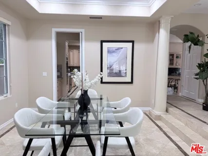 a dining room with furniture and window