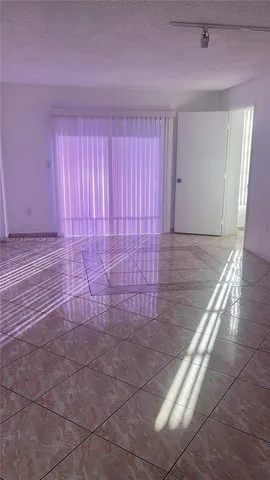 a view of an empty room and wooden floor