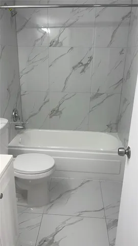 a bathroom with a toilet and a bathtub