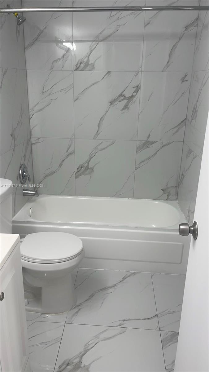 4801 Northwest 7th Street, Unit 70316 Miami, FL 33126 - Photo 5 of 9 a bathroom with a toilet and a bathtub