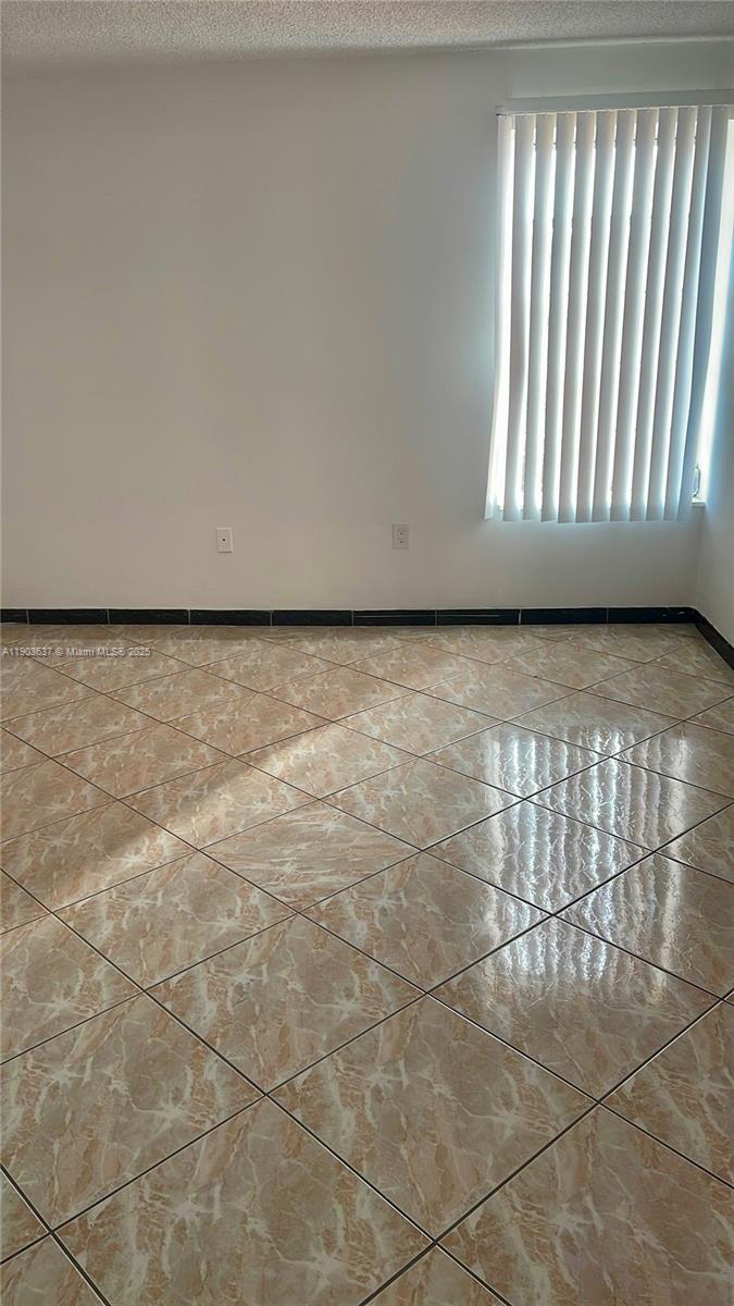 4801 Northwest 7th Street, Unit 70316 Miami, FL 33126 - Photo 7 of 9 a view of an empty room and window