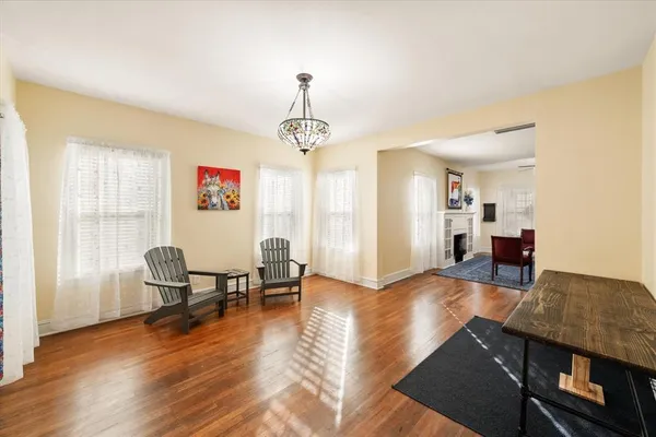 a living room with furniture and a chandelier