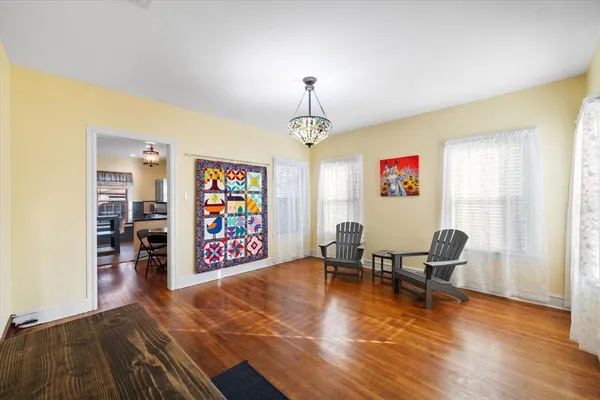 a view of a dining room with furniture and wooden floor