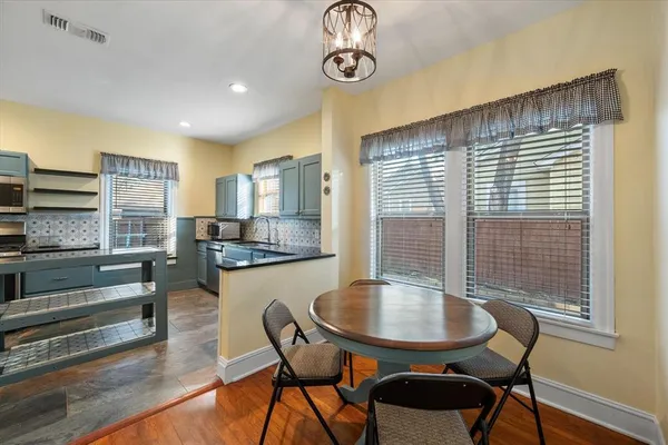 a kitchen with stainless steel appliances granite countertop a stove microwave and sink