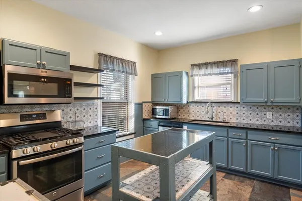 a kitchen that has a stove and a sink