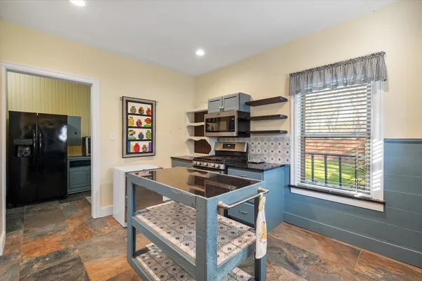 a kitchen with stainless steel appliances granite countertop a sink stove and refrigerator