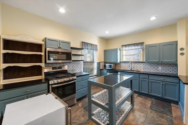 a kitchen with a refrigerator and cabinets