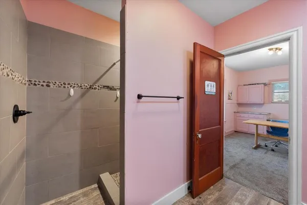 a bathroom with a granite countertop sink vanity and mirror