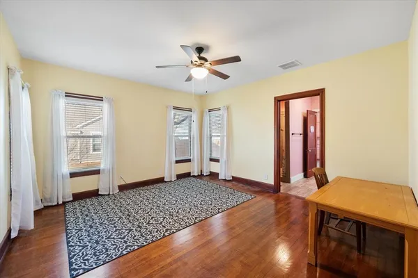 wooden floor in an empty room with a window