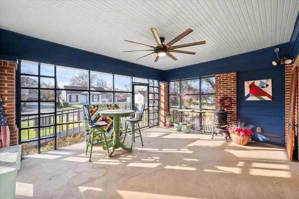 a view of a work space with wooden floor and windows