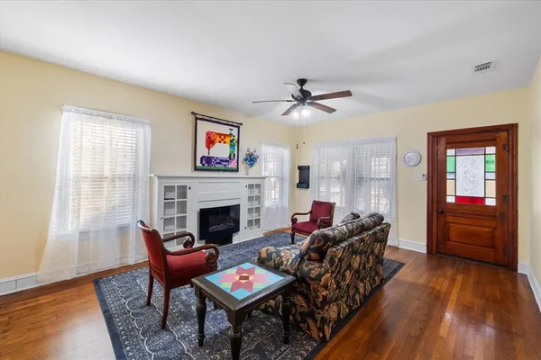 a living room with furniture and wooden floor