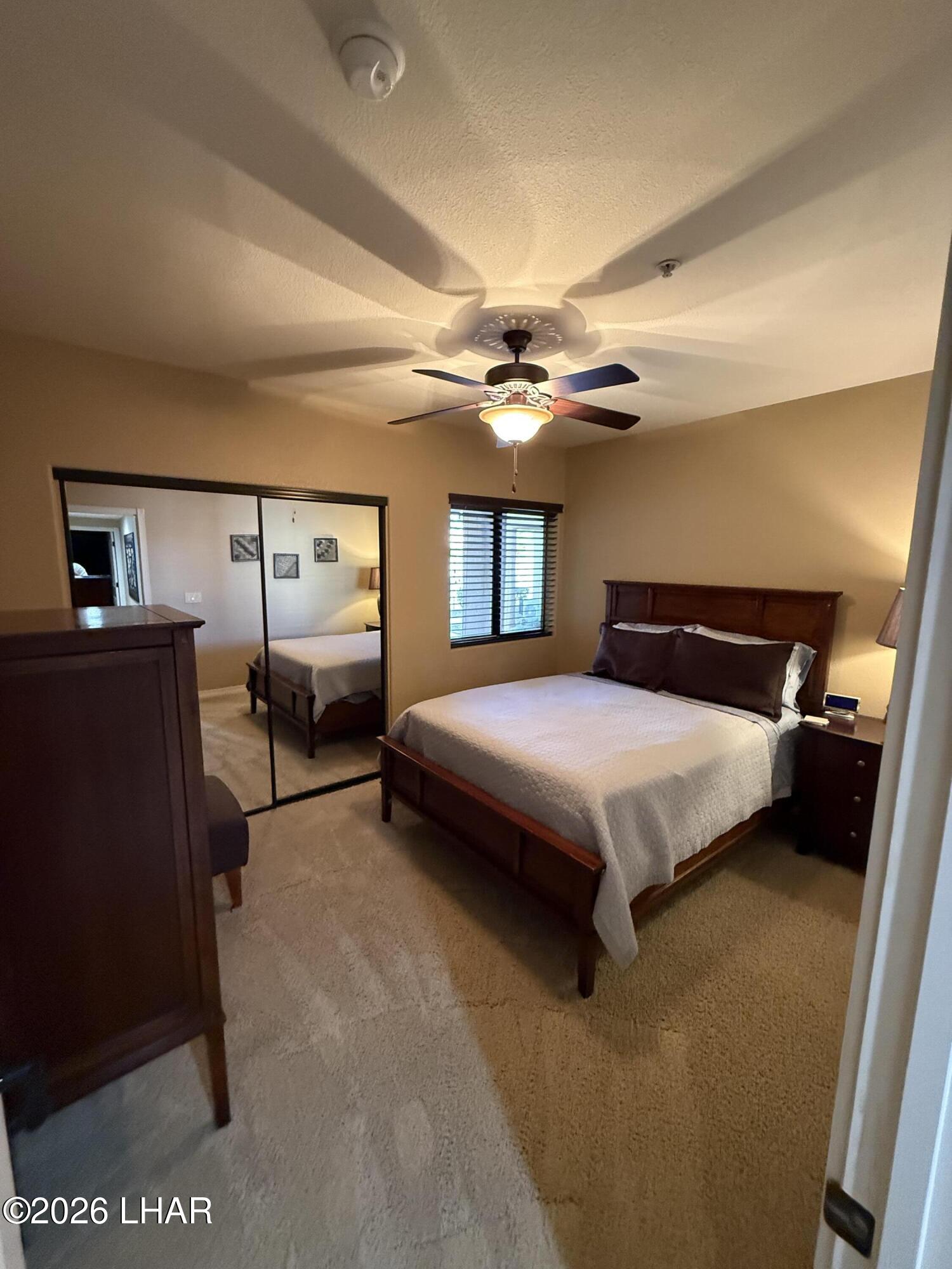 433 London Bridge Road, Unit B101 Lake Havasu City, AZ 86403 - Photo 35 of 35 a bedroom with a bed and a chandelier