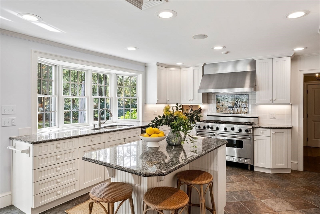 56 Ledgeways Wellesley, MA 02481 - Photo 14 of 42 a kitchen with stainless steel appliances granite countertop a stove a sink and a refrigerator