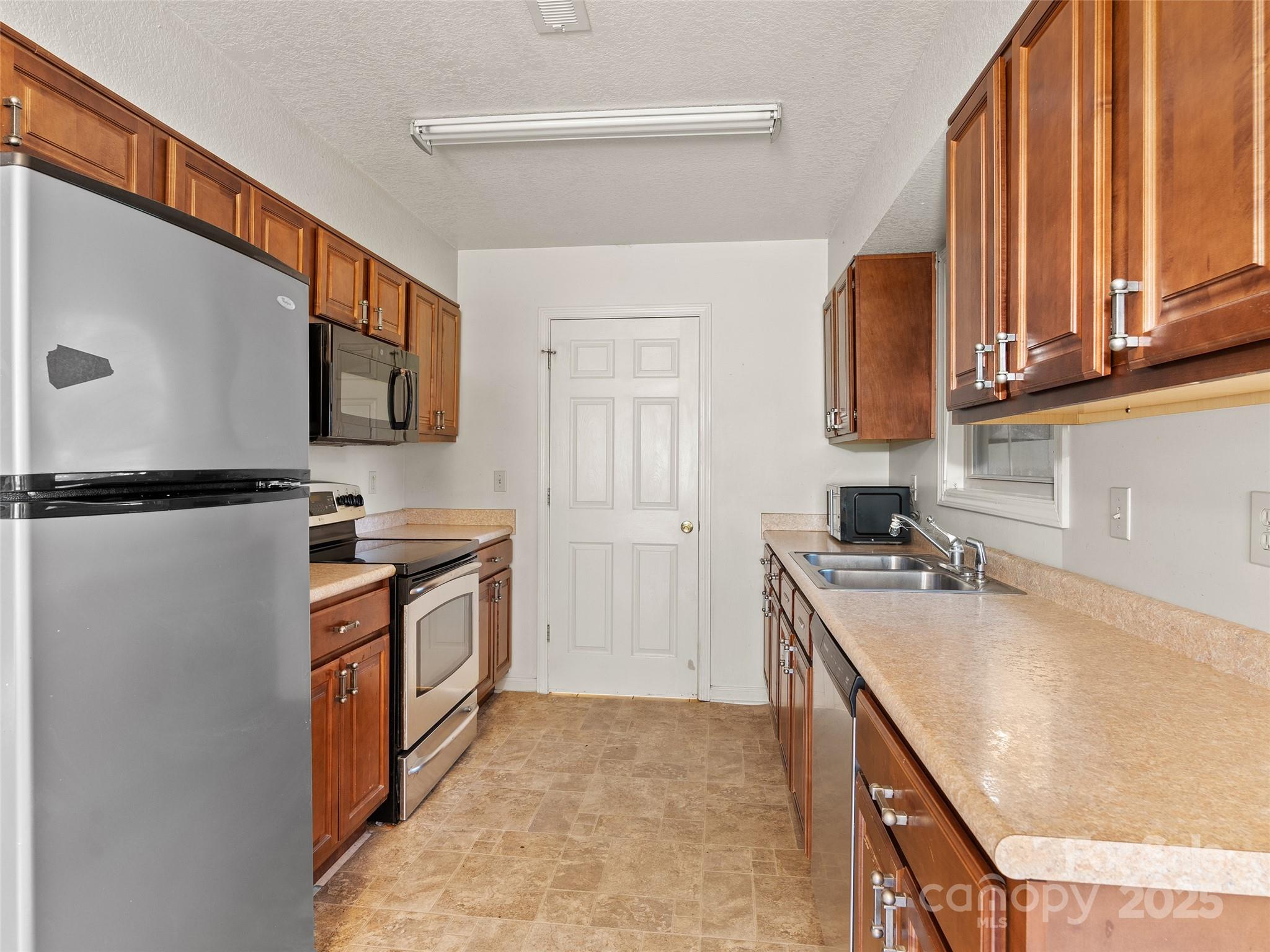 83 Indian Trace Road Maggie Valley, NC 28751 - Photo 12 of 21 a kitchen with stainless steel appliances granite countertop a sink stove and refrigerator