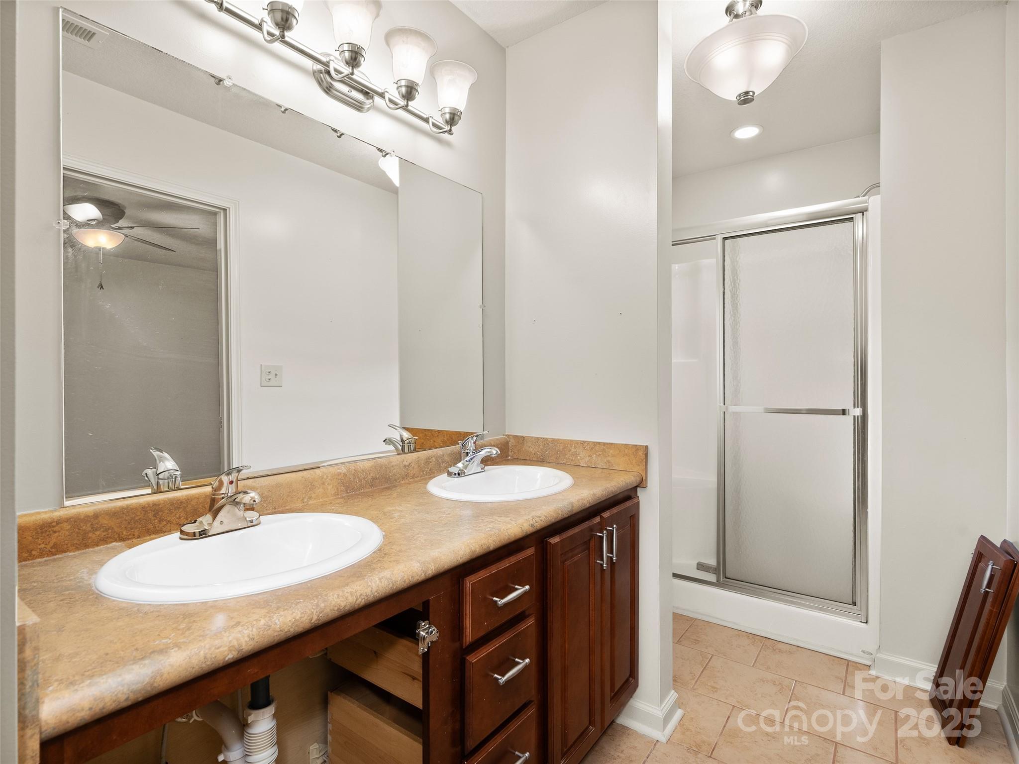 83 Indian Trace Road Maggie Valley, NC 28751 - Photo 17 of 21 a bathroom with a granite countertop sink a light fixture and a mirror