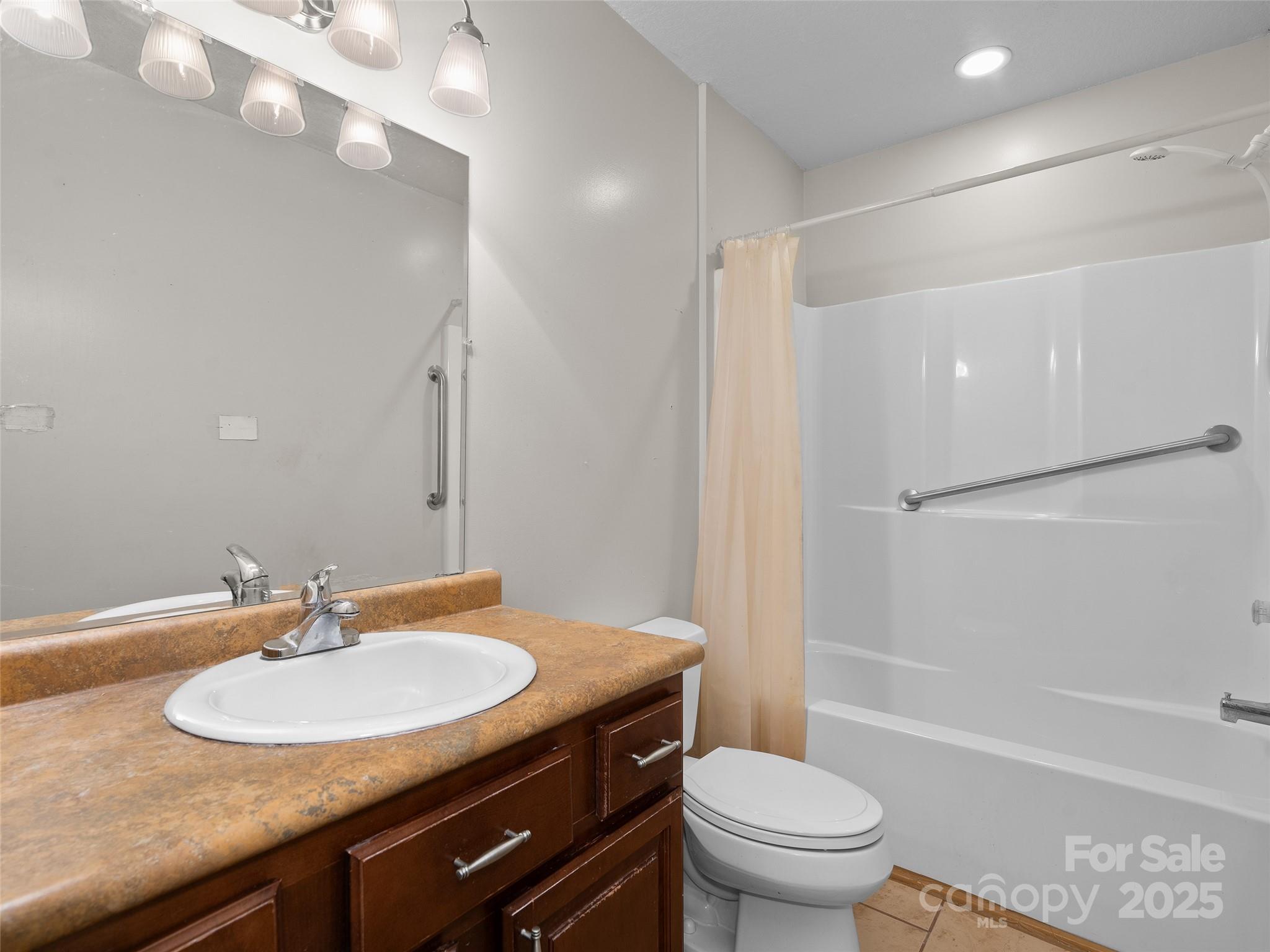 83 Indian Trace Road Maggie Valley, NC 28751 - Photo 19 of 21 a bathroom with a sink a toilet and shower