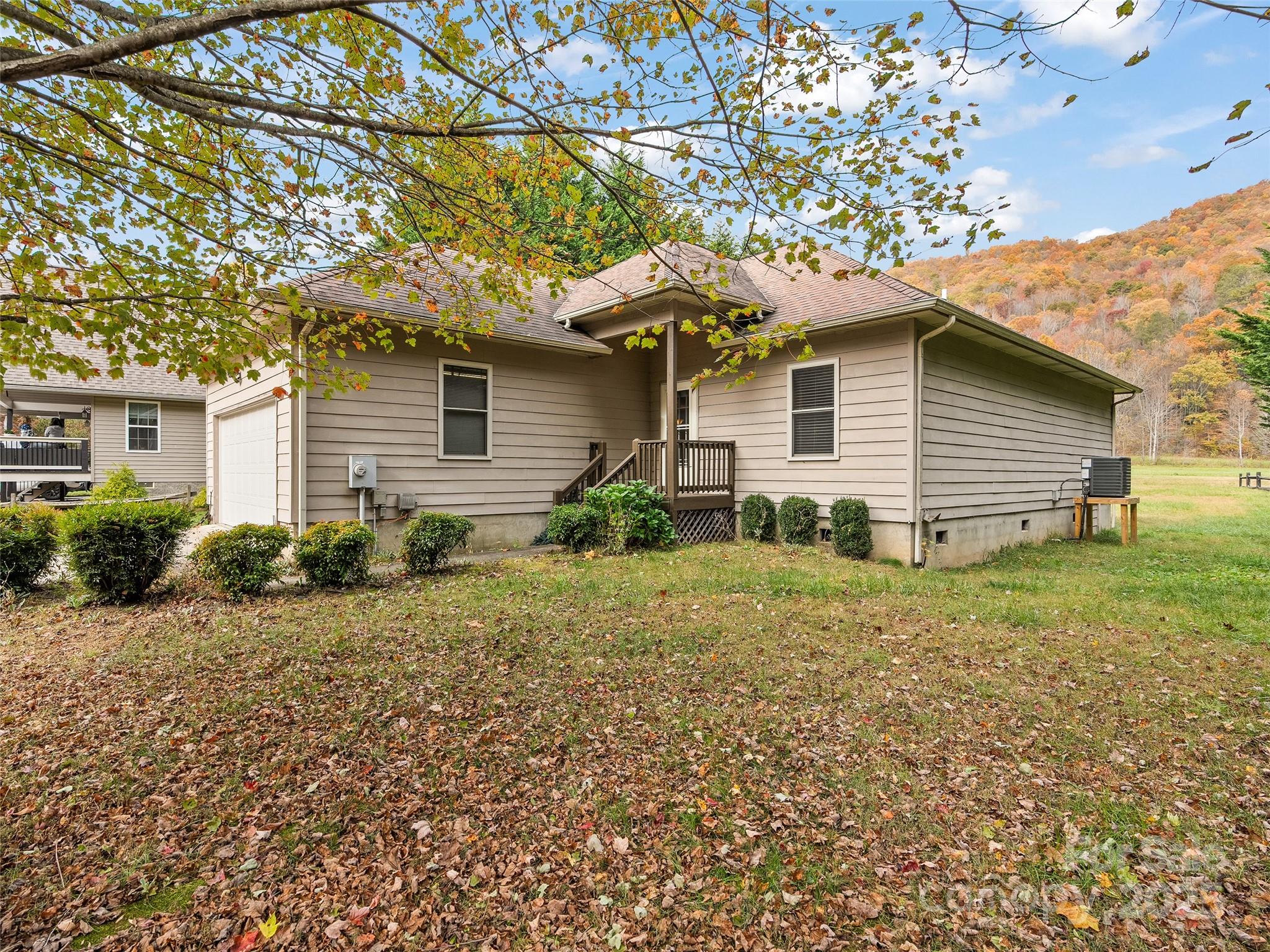 83 Indian Trace Road Maggie Valley, NC 28751 - Photo 2 of 21 a house that has a tree in front of it